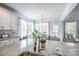 Kitchen island features granite countertops, stainless steel sink, and views of the breakfast area at 3992 Blue Dory Ln, Denver, NC 28037
