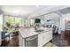 Kitchen island with sink and dishwasher with views of the breakfast area and living room at 3992 Blue Dory Ln, Denver, NC 28037