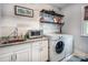 Laundry room with white cabinets, granite countertops, and a washer and dryer at 3992 Blue Dory Ln, Denver, NC 28037