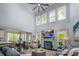 Bright living room with high ceilings, a fireplace, large windows, and elegant furnishings, creating an inviting space at 3992 Blue Dory Ln, Denver, NC 28037