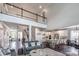 Open-concept living space with a view of the second-floor balcony, featuring a modern kitchen and cozy seating at 3992 Blue Dory Ln, Denver, NC 28037