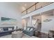 Open living room featuring a second-floor balcony, a comfortable seating arrangement, and dark hardwood floors at 3992 Blue Dory Ln, Denver, NC 28037