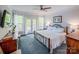 Comfortable main bedroom featuring French doors leading to deck, ceiling fan, and stylish decor at 3992 Blue Dory Ln, Denver, NC 28037