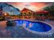 Backyard pool area featuring a covered patio, an outdoor dining set, and a brick-paved patio at 3992 Blue Dory Ln, Denver, NC 28037