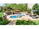 Beautiful pool area with a separate hot tub, fire pit, gazebo, and outdoor dining area at 3992 Blue Dory Ln, Denver, NC 28037