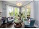 Bright sitting room with large windows, stylish decor, and comfortable seating, creating a welcoming atmosphere at 3992 Blue Dory Ln, Denver, NC 28037