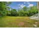 Expansive backyard with lush green grass and surrounding trees, perfect for outdoor activities and relaxation at 4021 Paisley Pl, Charlotte, NC 28208
