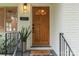 Close-up of a front door featuring a solid wood door, modern hardware, and stylish decor at 4021 Paisley Pl, Charlotte, NC 28208