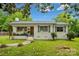 Charming brick home with green shutters, beautiful landscaping, and a well-maintained front yard at 4021 Paisley Pl, Charlotte, NC 28208