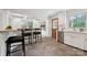 Stylish kitchen featuring bar stools, sleek countertops, and a view of updated appliances and fixtures at 4021 Paisley Pl, Charlotte, NC 28208