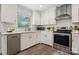Modern kitchen with stainless steel appliances, white subway tile backsplash, and gold hardware accents at 4021 Paisley Pl, Charlotte, NC 28208