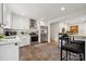 Bright kitchen featuring white cabinetry, stainless steel appliances, and a breakfast bar with seating at 4021 Paisley Pl, Charlotte, NC 28208
