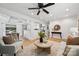 Open-concept living space with hardwood floors connecting the living room, dining area, and kitchen at 4021 Paisley Pl, Charlotte, NC 28208