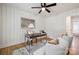 Bright home office with white-painted wood paneling, a modern desk, inviting chairs, and great natural light at 4021 Paisley Pl, Charlotte, NC 28208