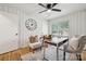 Spacious home office features white paneling, hardwood floors, natural light, a decorative clock, and stylish furnishings at 4021 Paisley Pl, Charlotte, NC 28208