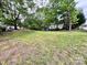 The backyard has a large grassy area and many trees at 419 S Spencer Ave, Spencer, NC 28159