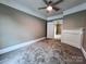 The room has carpeting, white trim, and a door leading to another room at 419 S Spencer Ave, Spencer, NC 28159