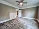 Bedroom features carpet, fan, fireplace and doorways to other rooms at 419 S Spencer Ave, Spencer, NC 28159
