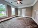 Bright bedroom with new carpet, large windows, and a ceiling fan, offering a comfortable and inviting space at 419 S Spencer Ave, Spencer, NC 28159