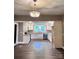 An open kitchen boasts stainless steel appliances, white cabinets, and a chandelier at 419 S Spencer Ave, Spencer, NC 28159