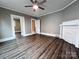 Comfortable living space with dark wood floors, fan, fireplace, and doorway leading to another room at 419 S Spencer Ave, Spencer, NC 28159