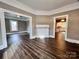Bright living room featuring elegant dark wood floors, a decorative fireplace, and entryways leading to other spaces at 419 S Spencer Ave, Spencer, NC 28159