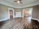 Spacious living area showcases wood floors, a ceiling fan, a cozy fireplace, and seamless transitions into other rooms at 419 S Spencer Ave, Spencer, NC 28159