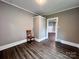A cozy living room with wood-look floors with an adjoining room and single chair at 419 S Spencer Ave, Spencer, NC 28159