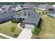 Aerial view of a beautiful home with a lush lawn and mature trees in a suburban neighborhood at 45523 Misty Bluff Dr, Charlotte, NC 28278
