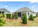 Backyard featuring a screened in porch and stone patio with lush landscaping at 45523 Misty Bluff Dr, Charlotte, NC 28278