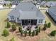 An aerial view of the backyard with a screened in porch and landscaped patio area at 45523 Misty Bluff Dr, Charlotte, NC 28278