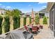 Backyard patio features an outdoor dining table and chairs, with a stone patio and grill at 45523 Misty Bluff Dr, Charlotte, NC 28278