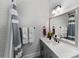 Bright bathroom featuring a tiled shower-tub combination, vanity, and a large mirror at 45523 Misty Bluff Dr, Charlotte, NC 28278