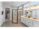Modern bathroom featuring a glass shower with stone floor, dual sink vanity and a walk-in closet at 45523 Misty Bluff Dr, Charlotte, NC 28278