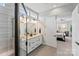 Bright bathroom with a glass shower, dual sink vanity, and a doorway to a bedroom at 45523 Misty Bluff Dr, Charlotte, NC 28278