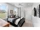 This bedroom features a four poster bed and a large window that provides natural light at 45523 Misty Bluff Dr, Charlotte, NC 28278