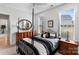 Stylish bedroom with a four-poster bed, bedside tables, and a neutral color palette at 45523 Misty Bluff Dr, Charlotte, NC 28278