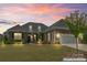 Charming two-story home with brick exterior, manicured lawn, and attached garage at 45523 Misty Bluff Dr, Charlotte, NC 28278