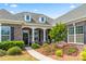 Inviting front entrance with stone accents, a charming front porch, and colorful flower beds at 45523 Misty Bluff Dr, Charlotte, NC 28278