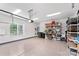 Clean, well lit garage with epoxy flooring and storage shelves with contents at 45523 Misty Bluff Dr, Charlotte, NC 28278