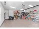 Bright garage with epoxy flooring and shelving for optimal storage and organization at 45523 Misty Bluff Dr, Charlotte, NC 28278