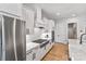 Well-equipped kitchen featuring white cabinets, stainless steel appliances, and a gas range at 45523 Misty Bluff Dr, Charlotte, NC 28278