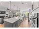 Spacious kitchen with a large island, stainless steel appliances, and an open layout to the living room at 45523 Misty Bluff Dr, Charlotte, NC 28278