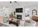 Cozy living room with a fireplace, large screen TV and comfortable seating arrangement at 45523 Misty Bluff Dr, Charlotte, NC 28278