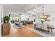Open-concept living space with hardwood floors, lots of natural light, and stylish furniture at 45523 Misty Bluff Dr, Charlotte, NC 28278
