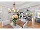 Elegant living room with a fireplace, hardwood floors, and a view of the outdoor patio at 45523 Misty Bluff Dr, Charlotte, NC 28278