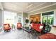 Welcoming sun room features an outdoor view, comfortable furniture, ceiling fan, and slate flooring at 45523 Misty Bluff Dr, Charlotte, NC 28278
