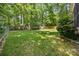 Large, fenced backyard offers ample space for recreation and outdoor activities amid mature trees at 4790 Cascade Ave, Rock Hill, SC 29732
