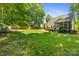Expansive backyard features a well-maintained lawn, wooden fence, and a screened in porch at 4790 Cascade Ave, Rock Hill, SC 29732