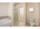 Bathroom featuring a glass door shower, soaking tub, and a toilet at 4790 Cascade Ave, Rock Hill, SC 29732
